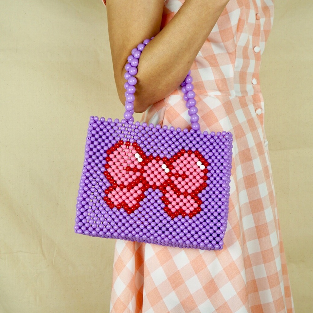 Handmade bow beaded tote handbag.